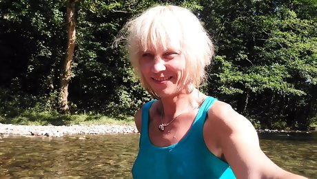 Sexy t-girl swimming in mountain river and wetting teal summer dress ...